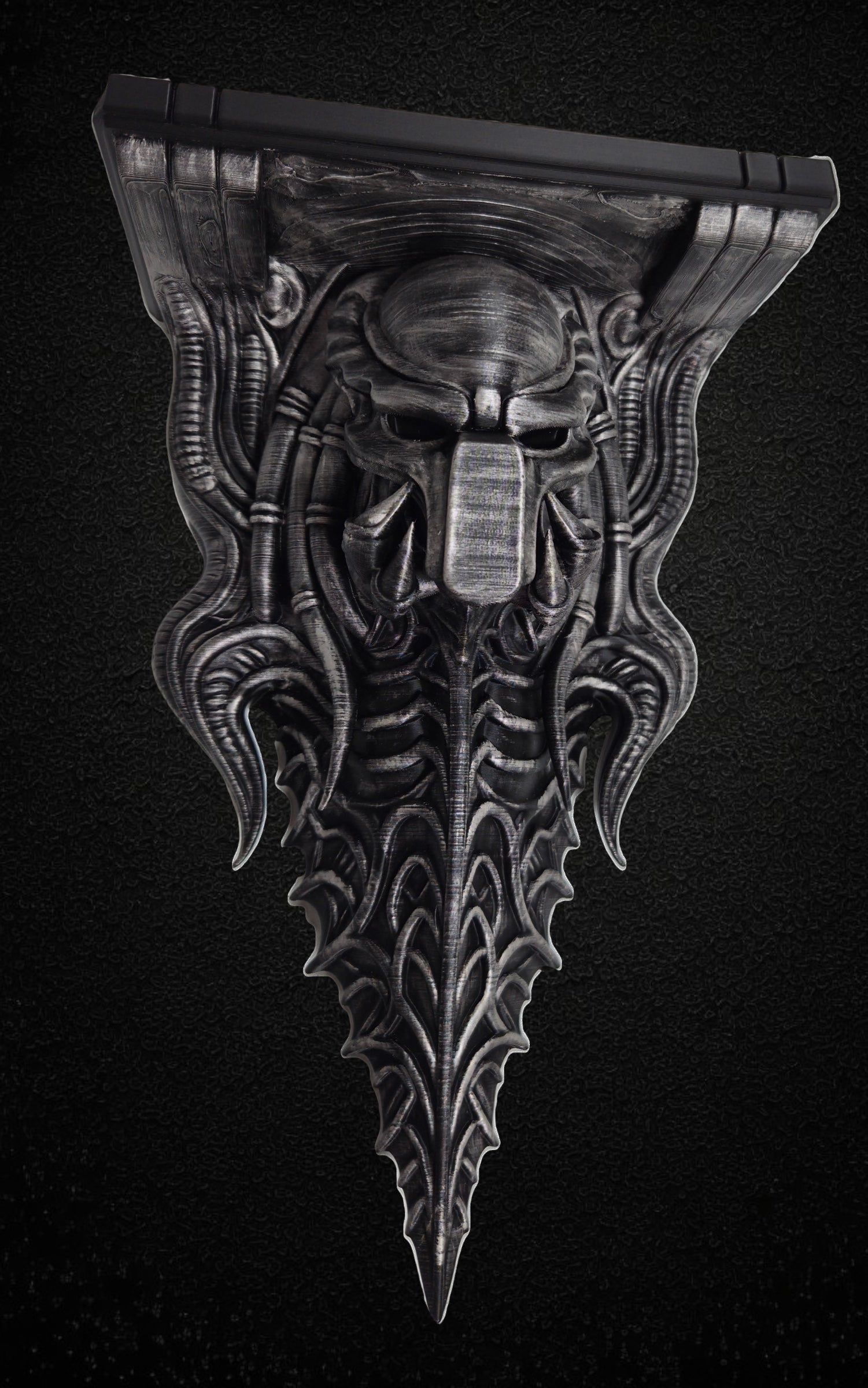 Blackspire Works gothic biomechanical wall shelf featuring a sentinel skull design with metallic hand-finished detail.